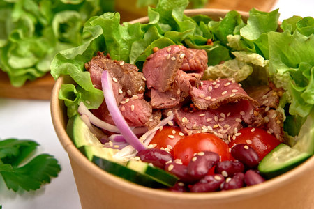 A Fresh and Nutritious Salad Bowl Featuring Tender Meat, Crisp Vegetables, and Flavorful Herbs for a Well-Balanced Meal Experienceの写真素材