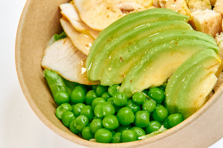 A Delicious Bowl of Fresh Chicken, Avocado, and Sweet Green Peas, Perfectly Crafted for a Nutritious...