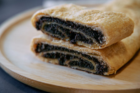 Deliciously Baked Pastry Filled with Rich Poppy Seed Mixture, Offering a Unique Blend of Flavors and Textures, Perfect for Dessert Lovers and Tea Pairingsの写真素材