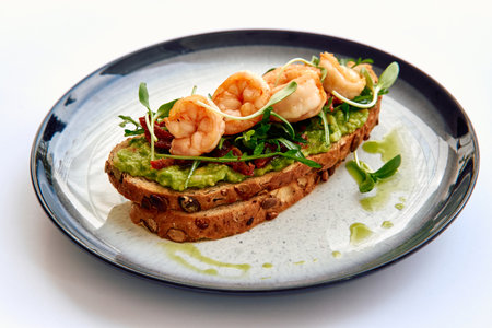 Deliciously Crafted Avocado Toast Garnished with Succulent Shrimp and Fresh Microgreens on Whole Grain Breadの写真素材