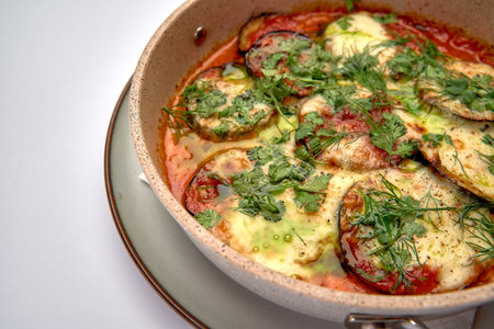 Delicious Baked Dish Featuring Layers of Zucchini, Tomatoes, and Cheese Topped with Fresh Herbs for a Flavorful Culinary Experienceの写真素材