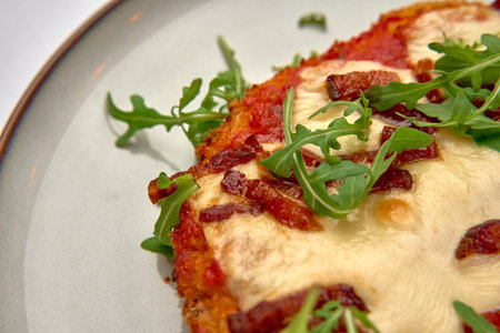 Deliciously Crafted Dish Featuring Melted Cheese, Crispy Bacon, and Fresh Arugula on a Golden Crust,...