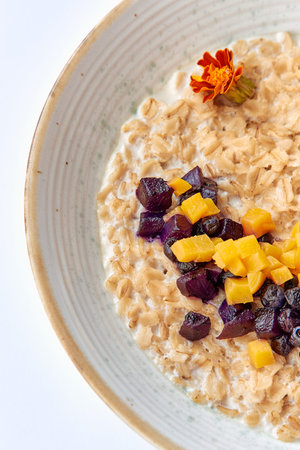Delicious Bowl of Creamy Oatmeal Topped with Colorful Exotic Fruits, Textured with Sweet Purple Yam...