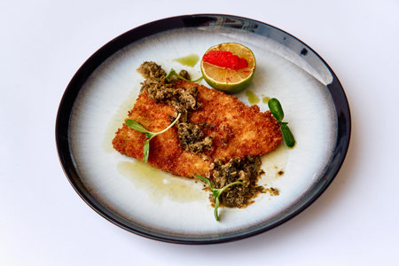 Crispy Fried Fish Garnished with Fresh Herbs, Citrus Zest, and a Touch of Garnish for an Exquisite...