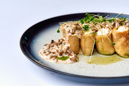 Deliciously Curated Plate of Savory Mushroom-Stuffed Crepes Topped with Creamy Sauce and Fresh...