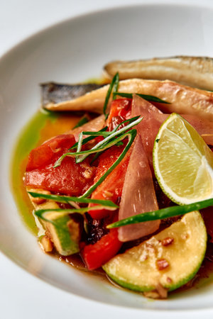 A Vibrant Dish Featuring Fresh Fish Garnished with Zesty Lime, Seasonal Vegetables, and Aromatic...