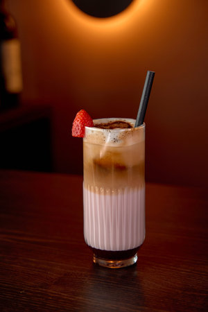 Delightful Refreshing Dessert Beverage with Layered Cream, Strawberry Garnish, and Rich Coffee...
