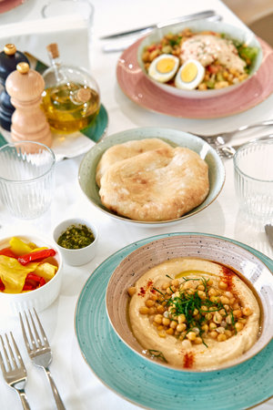 A Gastronomic Delight Featuring Delicious Hummus, Fresh Salad, Fluffy Pita Bread, and Vibrant...