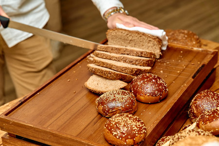 Artisan Bread Preparation: A Culinary Experience with Freshly Baked Loaves and Rolls Being Sliced...