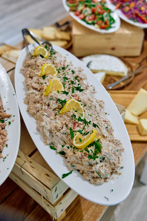A Bountiful Platter of Creamy Chicken Salad Garnished with Fresh Herbs and Citrus, Complemented by...