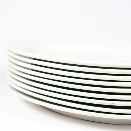 The plastic plates are stacked on a white background 