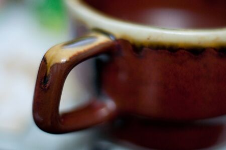 Orange ceramic cup isolated on a white background の写真素材