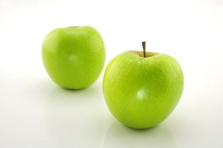 Green apple isolated on a white background の写真素材