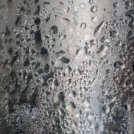lose-up of water drops on glass surface as background.