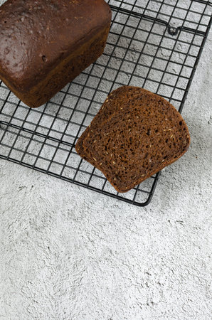 Homemade rye sourdough bread with coffee, molasses and flax seeds whole and cutの写真素材