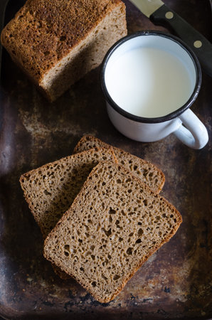 Homemade rye bread with cup of milkの写真素材