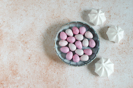 Dragee sweets in a plate and white meringue - sweets for Easterの写真素材
