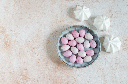 Dragee sweets in a plate and white meringue - sweets for Easterの写真素材