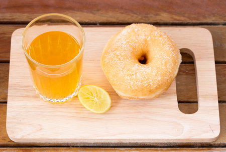 lemon tea and sweet donut on wood table.の写真素材