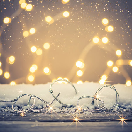 Christmas decorations on wooden background with bokeh lights and snow.の素材