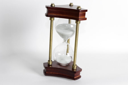 An antique sandglass on a white background.