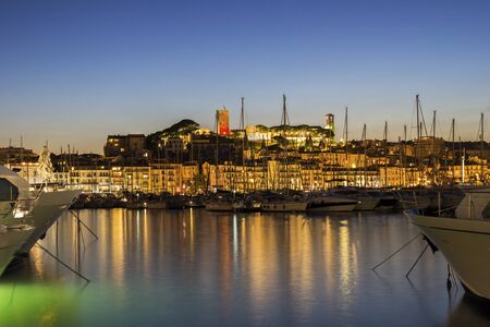 View on the harbor in Cannes on French Riviera in the eveningの写真素材