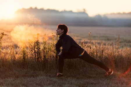 Young girl exercising outdoorsの写真素材