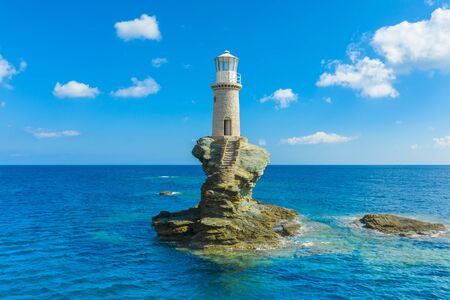 The beautiful Lighthouse Tourlitis of Chora in Andros island, Greeceの写真素材