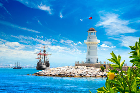 Landscape view with wooden sailing ships and Alanya port lighthouse, Alanya, Turkeyの写真素材