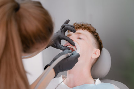 dentist drills teeth, caries treatment, patient lies on a dental chair, doctor drills teeth