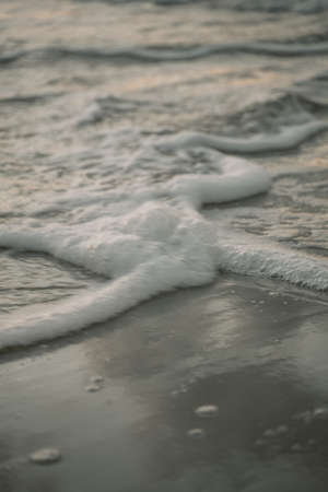 the approach of the sea wave close-up, foamy sea salt waterの写真素材