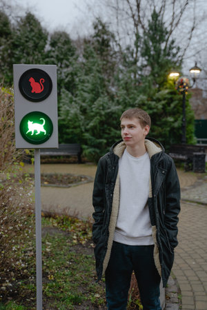 local landmark, cat traffic light, guy in winter jacket