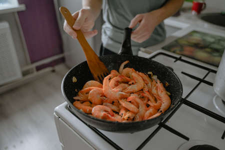 cooking seafood, frying shrimp in a pan, homemade foodの写真素材