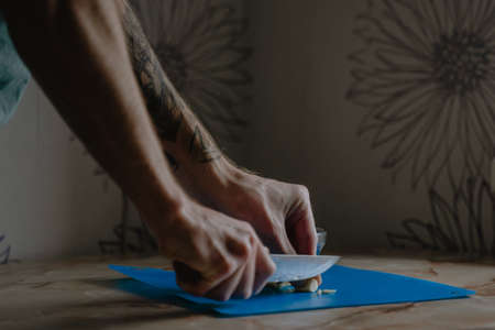 home cooking, male hands, cuts fresh garlic, close-upの写真素材