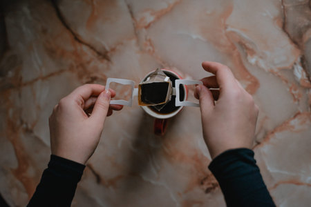 takes out a filter bag with coffee, alternative coffee brewing, top view