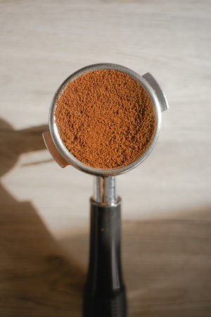 close-up of a holder filled with ground caffeine, top view, the process of making espressoの写真素材
