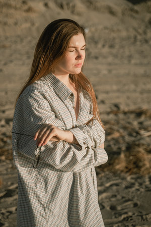 portrait of a red-haired girl with closed eyes, enjoys the rays of the sunの写真素材