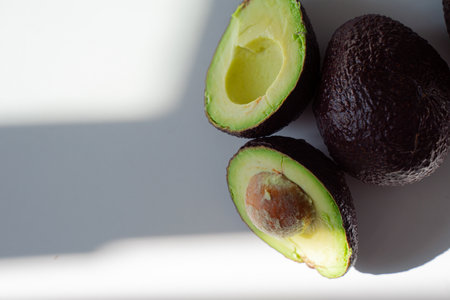 cut green avocado lying on the table top viewの写真素材