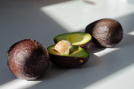 avocado lies on the table, cut tropical fruitの写真素材