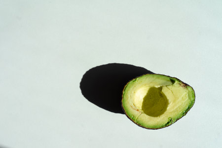 half an avocado lies on the table top viewの写真素材