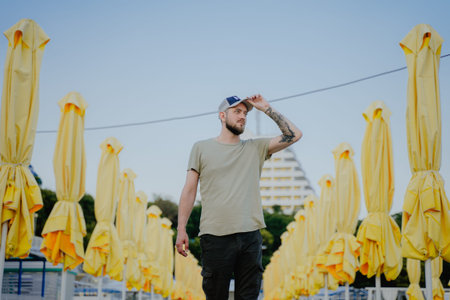 a man against the background of yellow umbrellas looks to the side