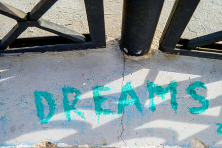 dream inscription on the asphalt with green paintの写真素材