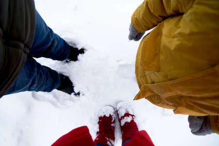 Low Section Of Man Standing On Snow Covered Fieldの写真素材