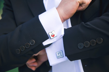 Groom showing cuff links