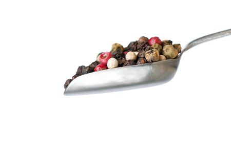 silver spoon with pepper on white backgroundの写真素材