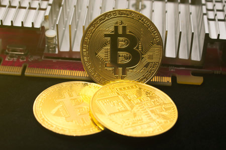 Bitcoin coin on the video card. Mining cryptocurrency. Bitcoin is shining.
