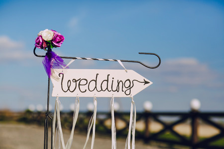 arrow labeled wedding on a blu skyの写真素材