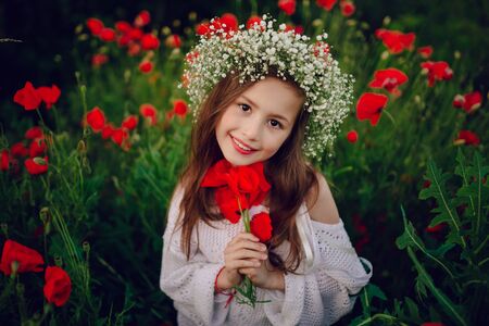 had a good girl at poppy wreath of flowersの写真素材