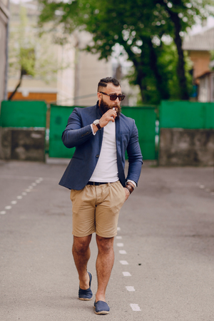 bearded man with e-cigarette outdoors on summer dayの写真素材