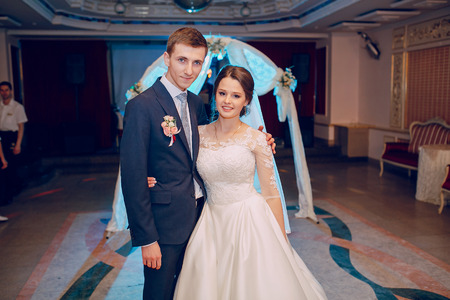 beautiful wedding couple on their wedding in a restaurantの写真素材